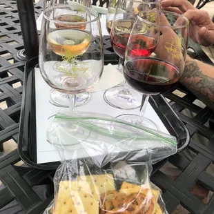 a glass of white wine, cheese and crackers