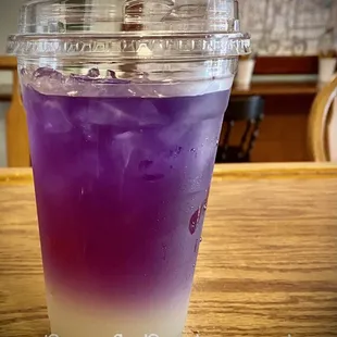 a purple drink in a plastic cup