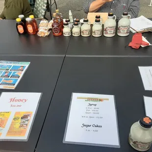 a table full of honey syrups
