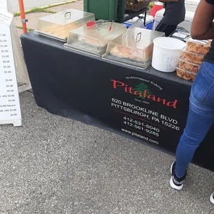 a woman standing in front of a table with food on it
