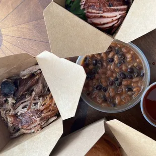 Duck breast (1/2 lb), pulled pork (1/2 lb), bun, baked beans