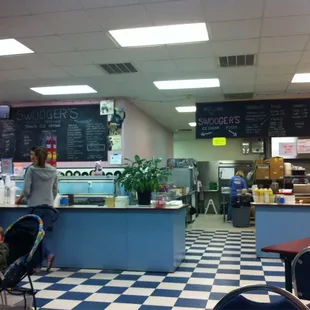 a baby in a stroller in a diner