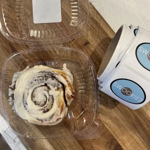 a cinnamon roll and a cup of coffee