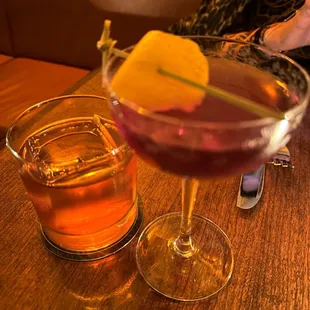 two glasses of alcohol on a table