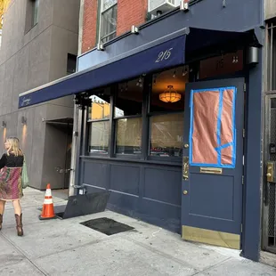a woman walking down the sidewalk