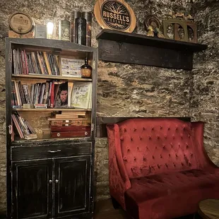 a red couch and a bookcase