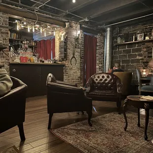 a living room with exposed brick walls