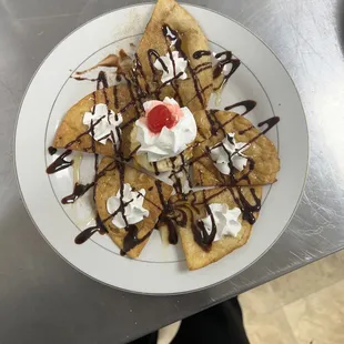 Delicious sopapilla  fried tortilla with cinnamon honey and little bit of sugar . Top it with whipped cream and chocolate