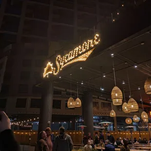 a crowd of people sitting outside a restaurant