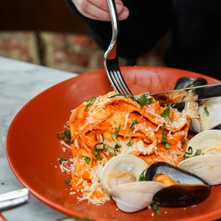 a plate of pasta with clams and clams