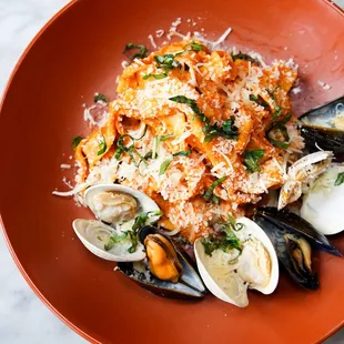 a plate of pasta with clams and clams