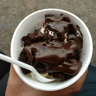 a person holding a cup of ice cream