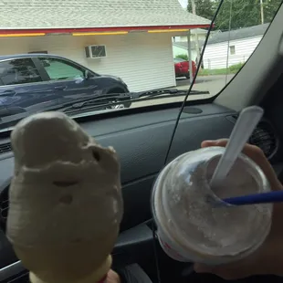 a person holding a cup of ice cream