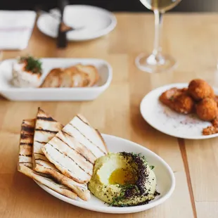 a plate of food and a glass of wine