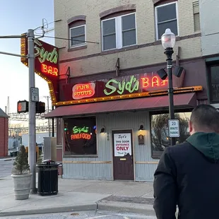 a man standing in front of a restaurant