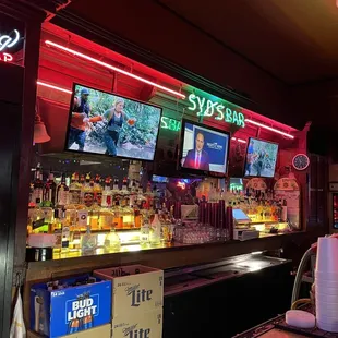 a bar with several televisions on the wall