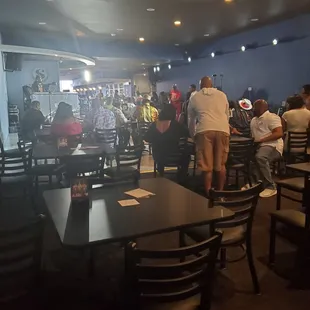 a group of people sitting at tables in a restaurant