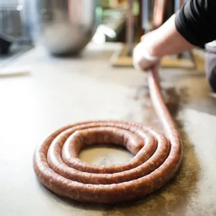 a sausage being rolled up on a counter