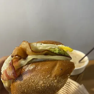 a hand holding a sandwich