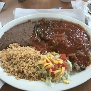 Steak with ranchero sauce, rice, and beans
