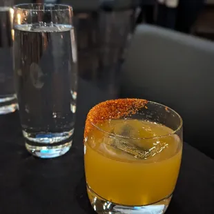 a glass of orange juice and a glass of water