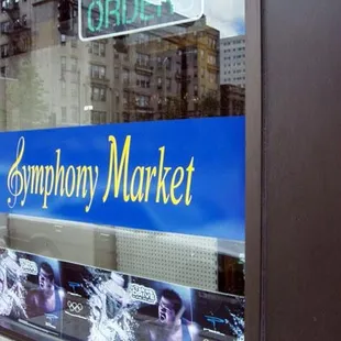 a storefront window with posters in the window