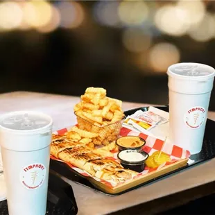 two trays of food and a drink
