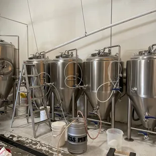 a row of stainless steel tanks