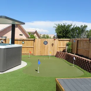 Putting green, concrete slab, and retaining wall, all done by SynLawn.