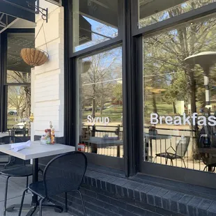 Exterior: Cafe table seating beside park, plus easy street parking