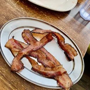 a plate of bacon on a table