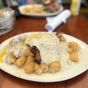 Kitchen Sink: biscuit, bacon, egg, hash browns covered in gravy  The Kitchen Sink