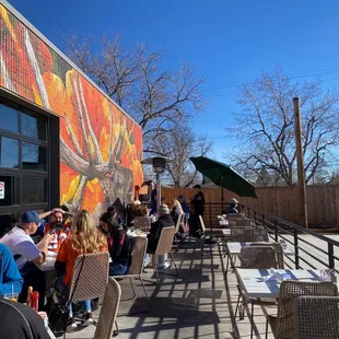 a group of people sitting outside of a restaurant