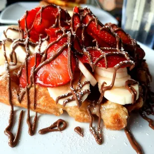 Close-up of original waffle with strawberries, bananas, and nutella
