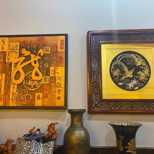 vases and paintings on a wall