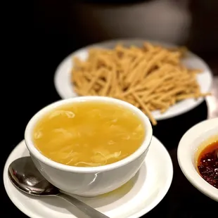 a bowl of soup and a plate of crackers