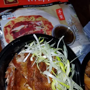 Half a peking duck with green onions, moo shu wrappers, and hoisin sauce