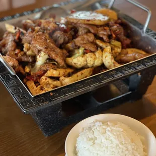 a bowl of rice and a plate of meat