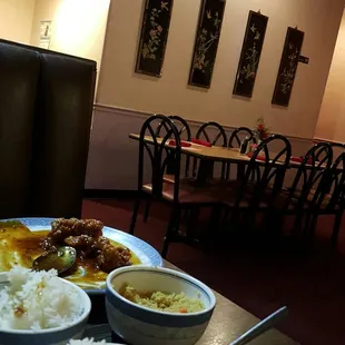 a table with bowls of rice and bowls of soup
