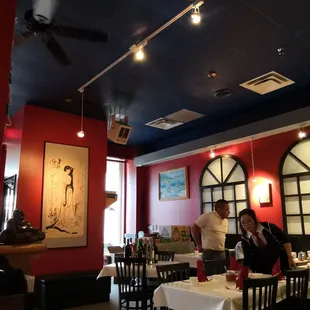 a restaurant with red walls and black ceiling
