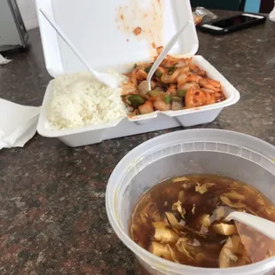 a bowl of soup and a container of rice