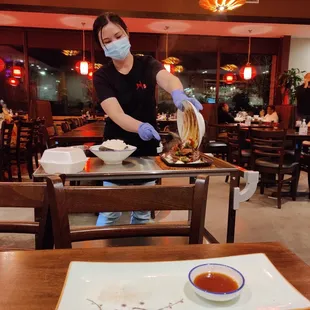 The sizzling black pepper beef comes out on a cart, and they pour it over the skillet.  It's a fun show.