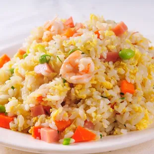 a plate of fried rice with shrimp and carrots