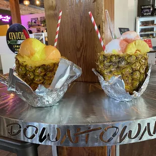 two pineapples on a table