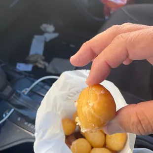 a hand holding a donut