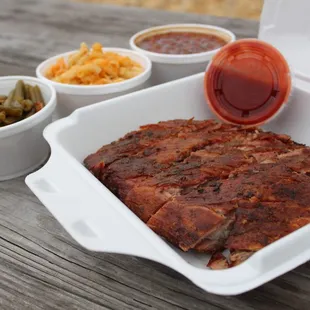 a tray of meat and sides