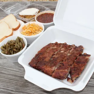 a tray of meat and side dishes