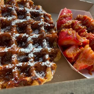 Dulce de leche waffles with strawberries. It has the dulce sauce drizzle but unfortunately they&apos;re out of the dulce crumbles