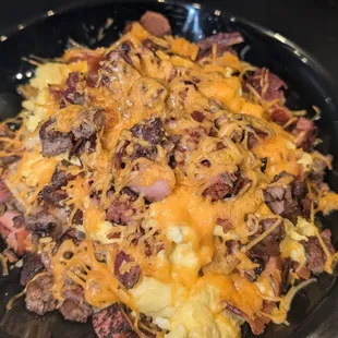 breakfast scrambler with ham, sausage, bacon, eggs, and cheese