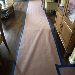 The walkway from front door entrance to the upstairs hallway and bedroom were covered to protect flooring.